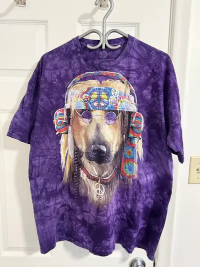 Purple tie-dye t-shirt. Features a large graphic of a dog wearing headphones and peace symbols. Dyed...