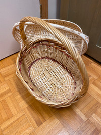 Two wicker hand baskets with handles