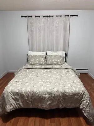 Modern queen size bed frame. Has a sleek grey upholstered headboard. Frame is black metal. Super stu...