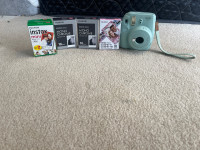 instax Polaroid camera light blue with film