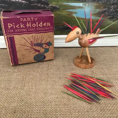 This vintage wooden bird toothpick holder is a fun addition to a mid century kitsch barware collecti...