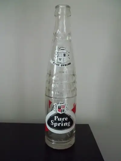 A "Pure Spring" glass soda pop bottle It's 10 fl. ozs.and 9.75 inches tall Bright, not faded at all...