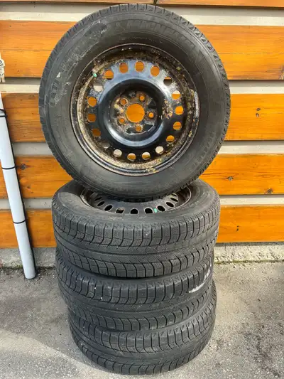 Selling 4 Michelin Latitude 225-65-17 winter tires on steel rims in good condition. Two tires are 9/...