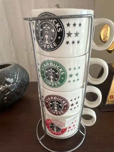 Add a touch of caffeinated charm to your kitchen with this set of four Starbucks stacking mugs, comp...