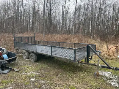 This is a sturdy tandem axle utility trailer, ready for hauling! It shows signs of use, as you can s...