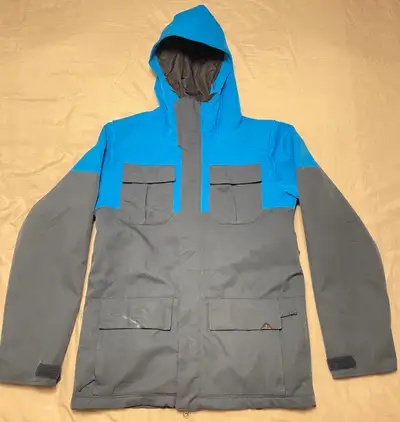 VOLCOM snowboard jacket in classic blue and black colours has a 15,000mm waterproof rating and a 15,...