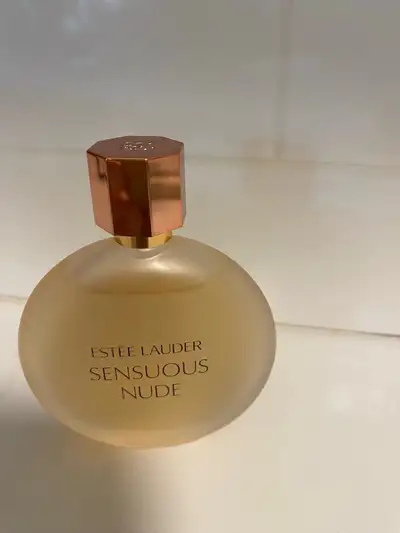 This is a new bottle of Estee Lauder Sensuous Nude perfume, a soft and warm fragrance with notes of...