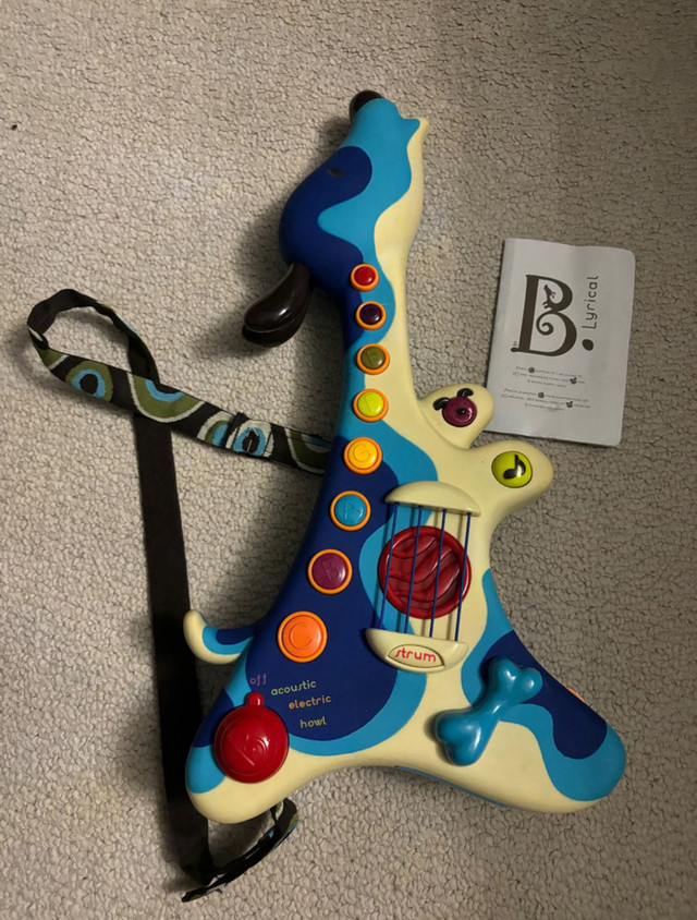 B. Toys Lyrical Guitar strum in Toys in Ottawa