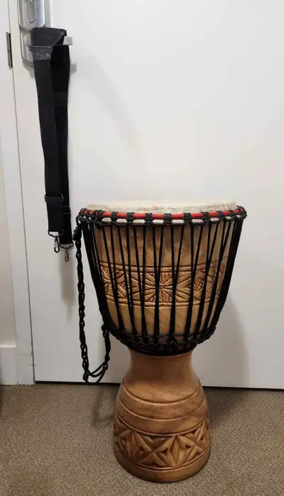 This large hand carved  Djembe drum is (24.5” tall by 14” high), View more