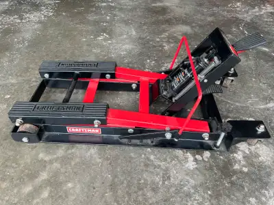 Sears brand pedal operated hydraulic bike lift. 1500 lb capacity. 16 1/4” at full height and approxi...