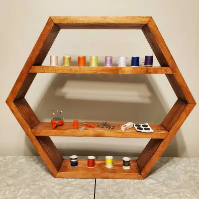 Pine hexagon shelf with Bombay Mahogany stain. H: 18" x W: 21" x D: 3.5" Made by Gonzo Factotum Chec...