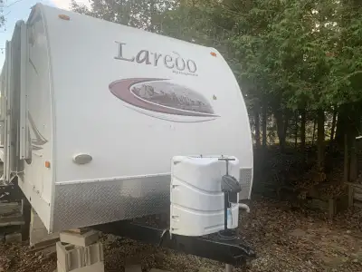 The Keystone Laredo 29BHS is 33 feet in length and has a private front master suite with a queen bed...