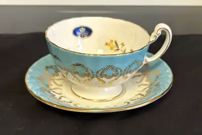 This is a beautiful Aynsley bone china teacup and saucer set, pattern #2976. The teacup features a d...