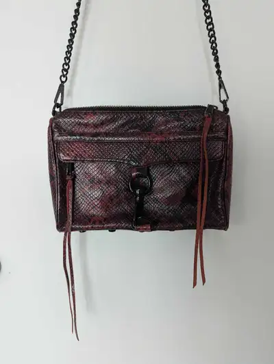 Elevate your style with this Rebecca Minkoff snakeskin leather crossbody bag, featuring a chic chain...