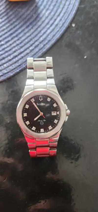 This is a Bulova Marine Star watch, adorned with 10 genuine diamonds that add a touch of elegance. T...