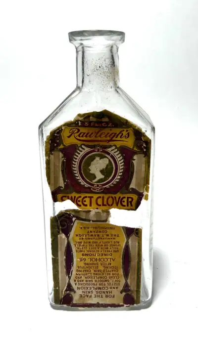 Vintage W.T. Rawleigh Co. glass bottle with original Rawleigh’s Sweet Clover label remnants. Embossi...