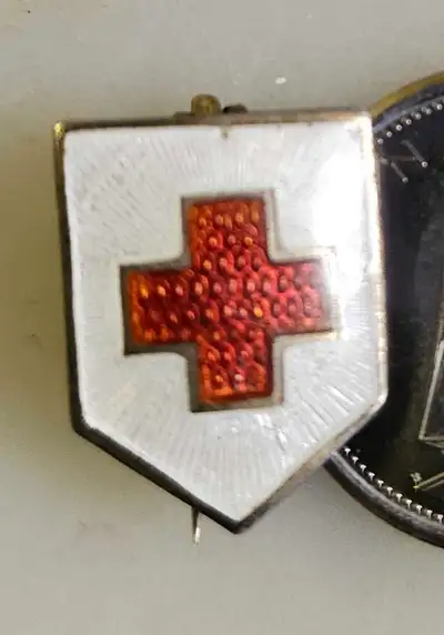 This is a striking Red Cross pin, perfect for collectors or anyone with an interest in historical me...