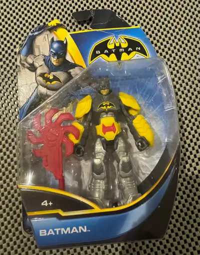 I'm selling a new, in-package Batman action figure, perfect for collectors or kids who love superher...