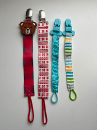 Four baby pacifier clips