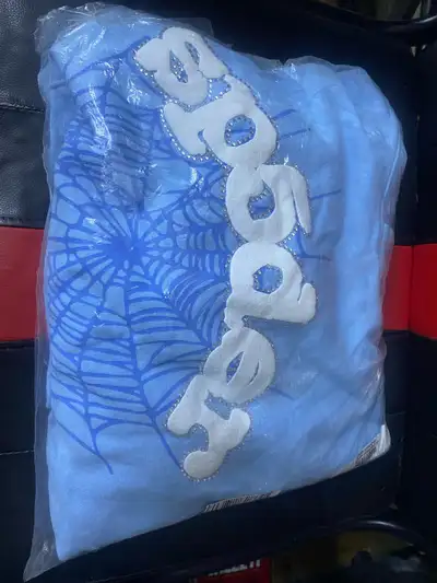 Get your hands on this brand new Spider hoodie, size medium! The hoodie is baby blue with the signat...