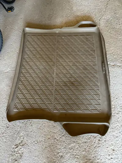 A beige cargo liner for a vehicle. It was from my brothers Volvo xc70 I believe and been in storage...