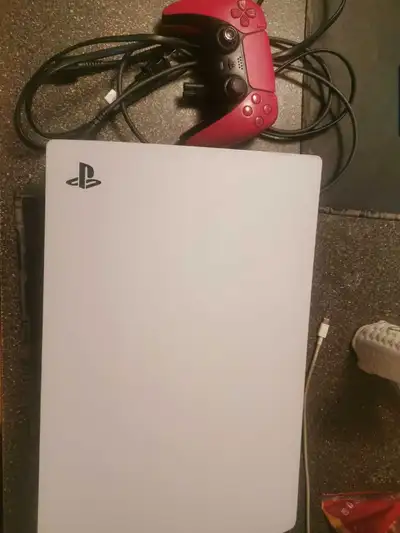 Ps5 avec une manette rouge ps5 avec fil HDMI avec un autre fil nécessaire et un chargeur pour la man...