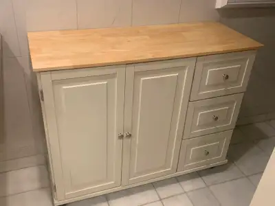 Mobile kitchen cabinet with 2 doors with 3 rows of shelving inside and 3 Large drawers with lots of...