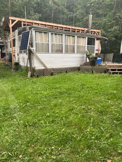 Golden Falcon trailer and addition on established lot. Queen size bedroom, single bed + double size...