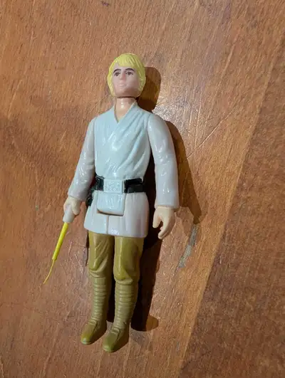 Spectacular Mint example of the Blonde Farmboy equipped with an authentic yellow lightsaber stored s...