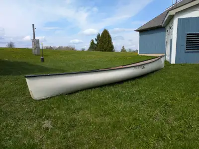 Light 0ff-white color hull with dark gunwales Interior has nice wooden thwarts and comfy woven seats...