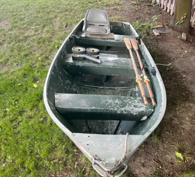 1976 Sears Game Fisher tin boat. Car Topper Comes with oars, seat, wheels and 3 rod holders Cash onl...