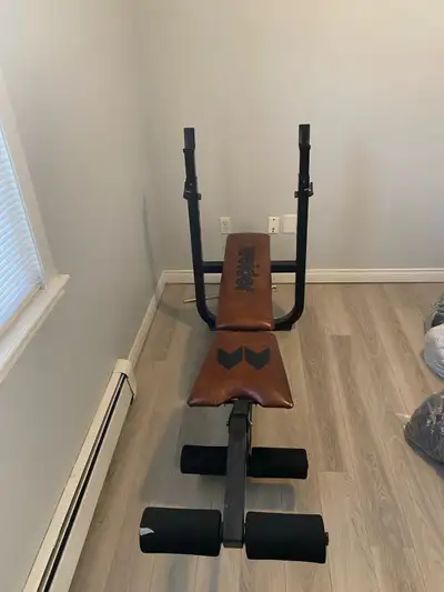 Adjustable bench-press with leg extension attachment for sale. Does not come with barbell or weights...