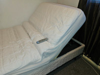 Adjustable bed with remote and mattress cover.