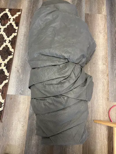 This is a used grey car cover, perfect for protecting your vehicle from the elements. It's in good c...