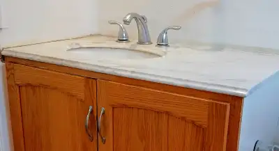 Bathroom vanity top, sink and faucet. 37"W x 22"D top is made from marble, grey color. Used, just ne...