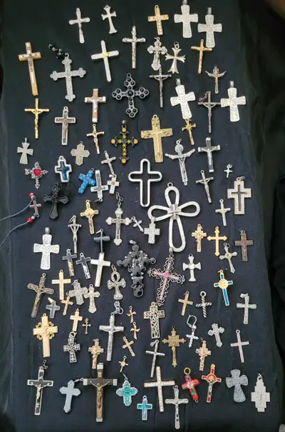 Large variety of religious items like crucifix, rosary, pendants, and sacred icons made of a variety...