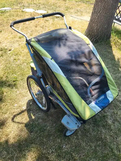 Double chariot stroller. Includes stroller wheels, jogging wheel and bike attachment and flag. West...