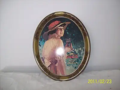 I have a vintage Coca cola oval metal tray of a girl drinking coca cola, $50.
