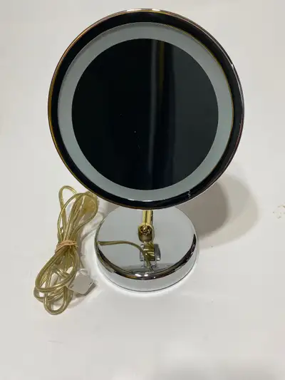 Available if posted. Daniele Enterprises brand. Silver and gold tone. 10x magnification. 2 light set...