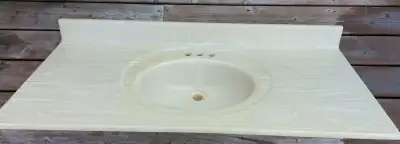 Beige, marble vanity top with built-in oval sink, with backsplash. It is in very good condition, wit...