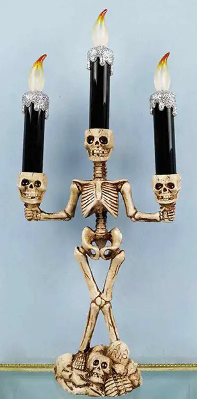 "SKELETON CANDELABRA" stands 14.25" H. 3 Candles flicker. NOTE: Requires 3 x "AAA" Batteries (not in...