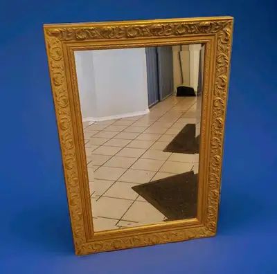 Enhance your space with this large vintage beveled wall mirror featuring an ornate, detailed gold-co...