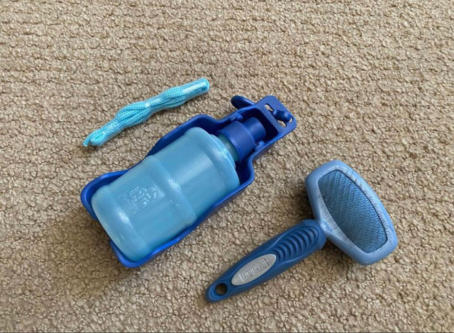 Doble sided dog brush and portable water bottle in Accessories in Calgary