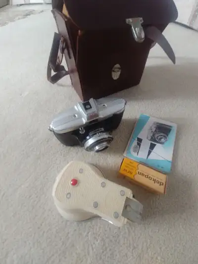 Camera comes with case . flash attachment and 1 roll of film and instruction manual