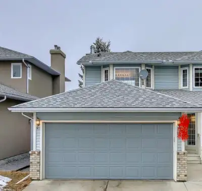 Double garage door gray color There are some hail marks/dents on the surface from a previous hailsto...