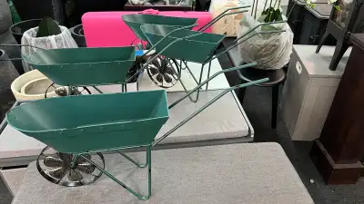 Green Wheelbarrow Planter Functional green wheelbarrow planter for garden decoration