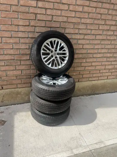 Selling a complete set of genuine Toyota OEM alloy wheels with Continental ProContact TX all-season...