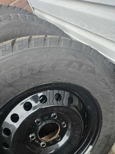 I am selling a set of four Bridgestone Blizzak DM-V2 snow tires, size 265/65R17, mounted on black st...