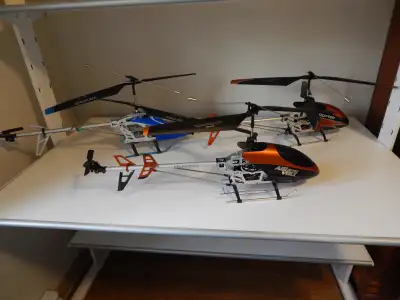 Three mechanically sound, working helicopters, with two extra batteries (5 total) and charger. All t...