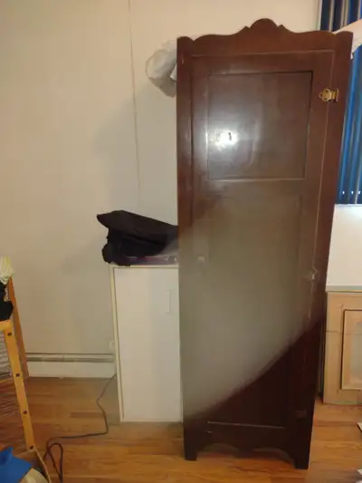 Wood armoire/penderie with rod on door for ties/belts. Two side rods for shoes. Dimensions 62" x 20"...